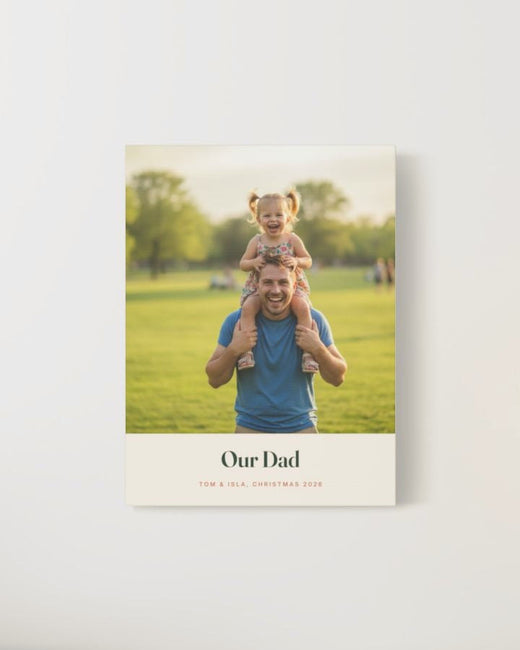 Our Dad photo canvas of a father carrying his laughing daughter on his shoulders, with the example names Tom and Isla, on a pale wall
