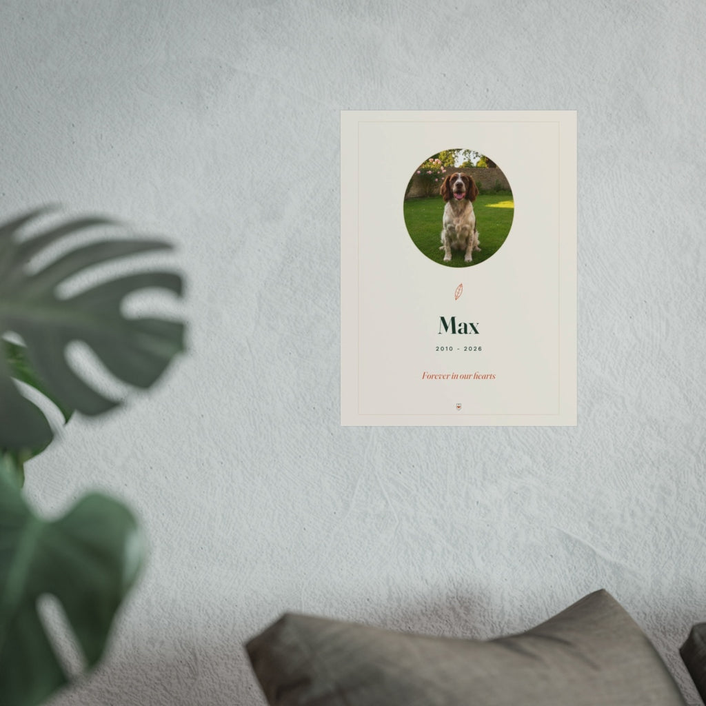Pet memorial print mock-up hung on a pale textured wall above a grey sofa, with a monstera leaf in the foreground