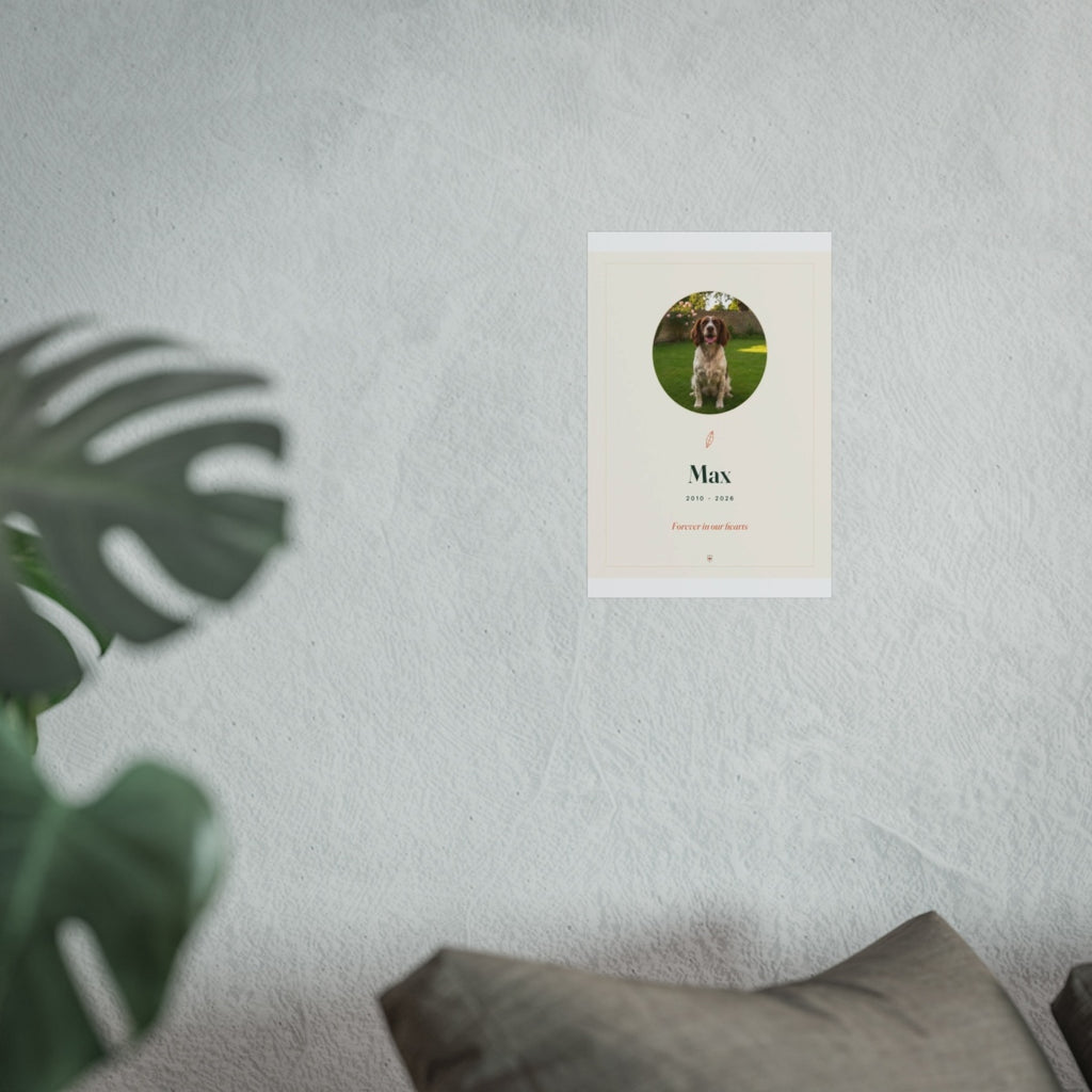 Pet memorial print mock-up shown smaller on the pale wall above the grey sofa, monstera leaf in front