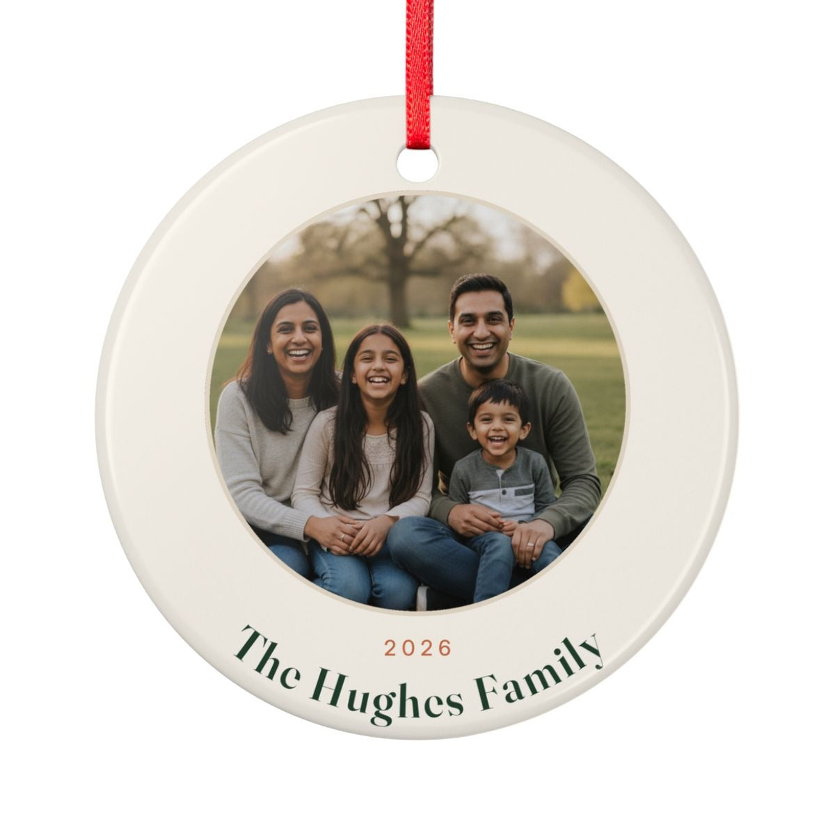 Family photo ceramic Christmas ornament mock-up with a family of four in a park, '2026' and 'The Hughes Family'