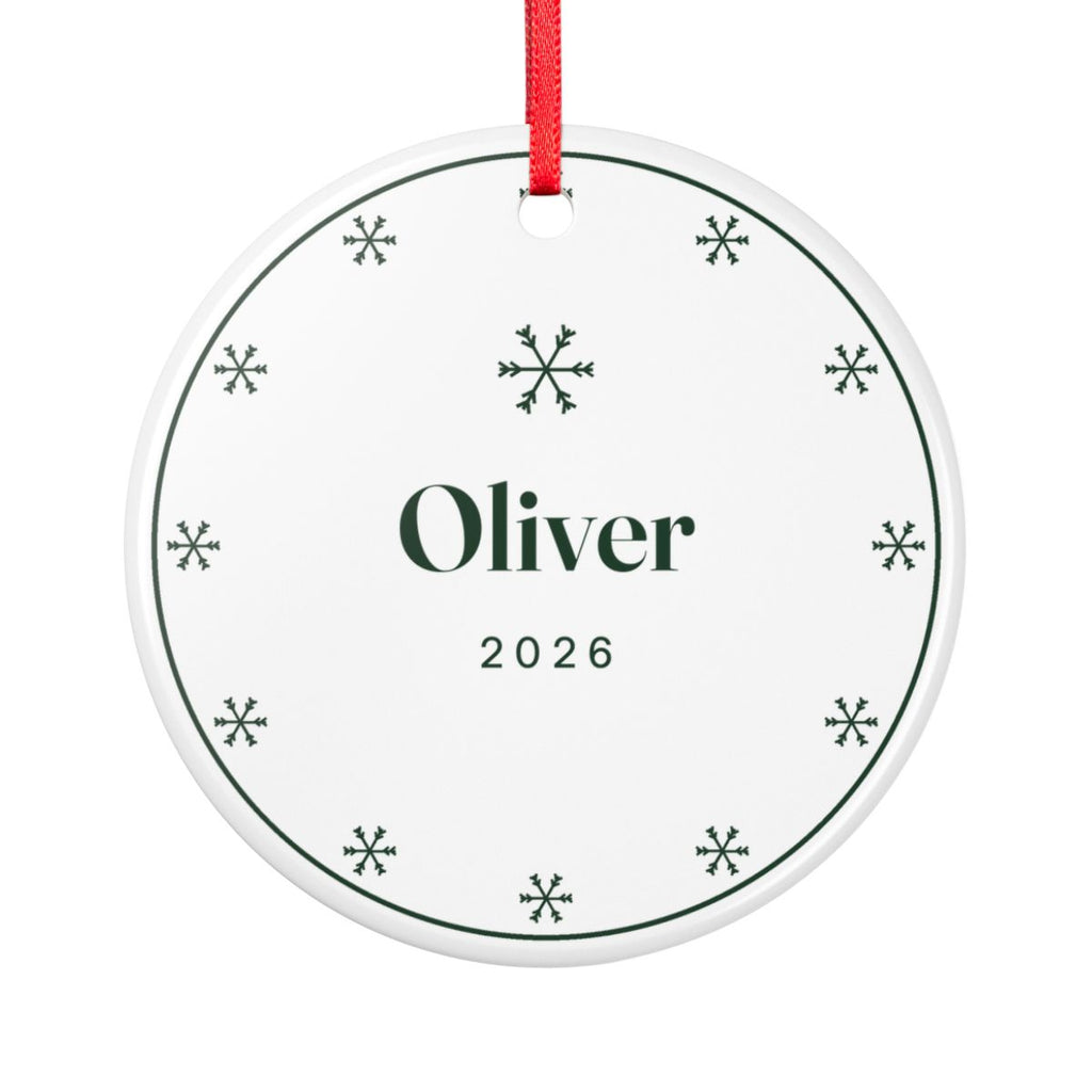 Snowflake ceramic Christmas ornament mock-up seen from the other side, with the same ring of green snowflakes, 'Oliver' and '2026'