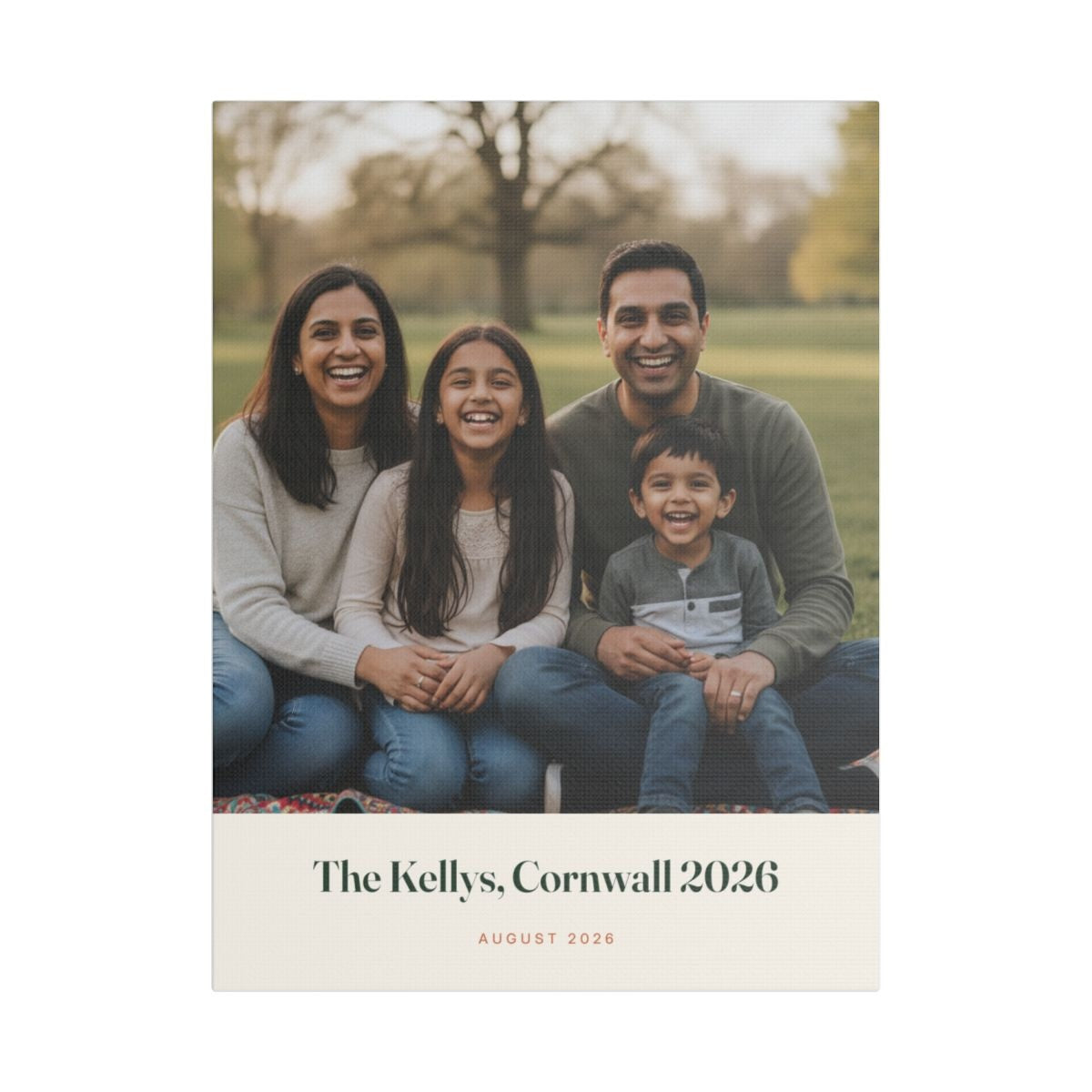 Personalised family photo canvas mock-up with a sample family of four in a park, captioned 'The Kellys, Cornwall 2026'