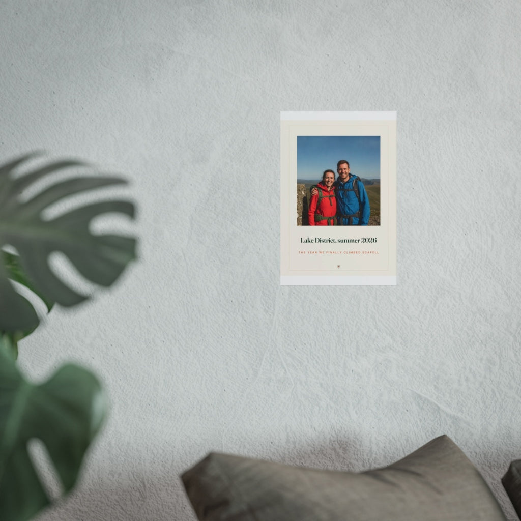 Photo print with caption mock-up in the smaller size on the grey wall above a sofa cushion, hikers photo in view