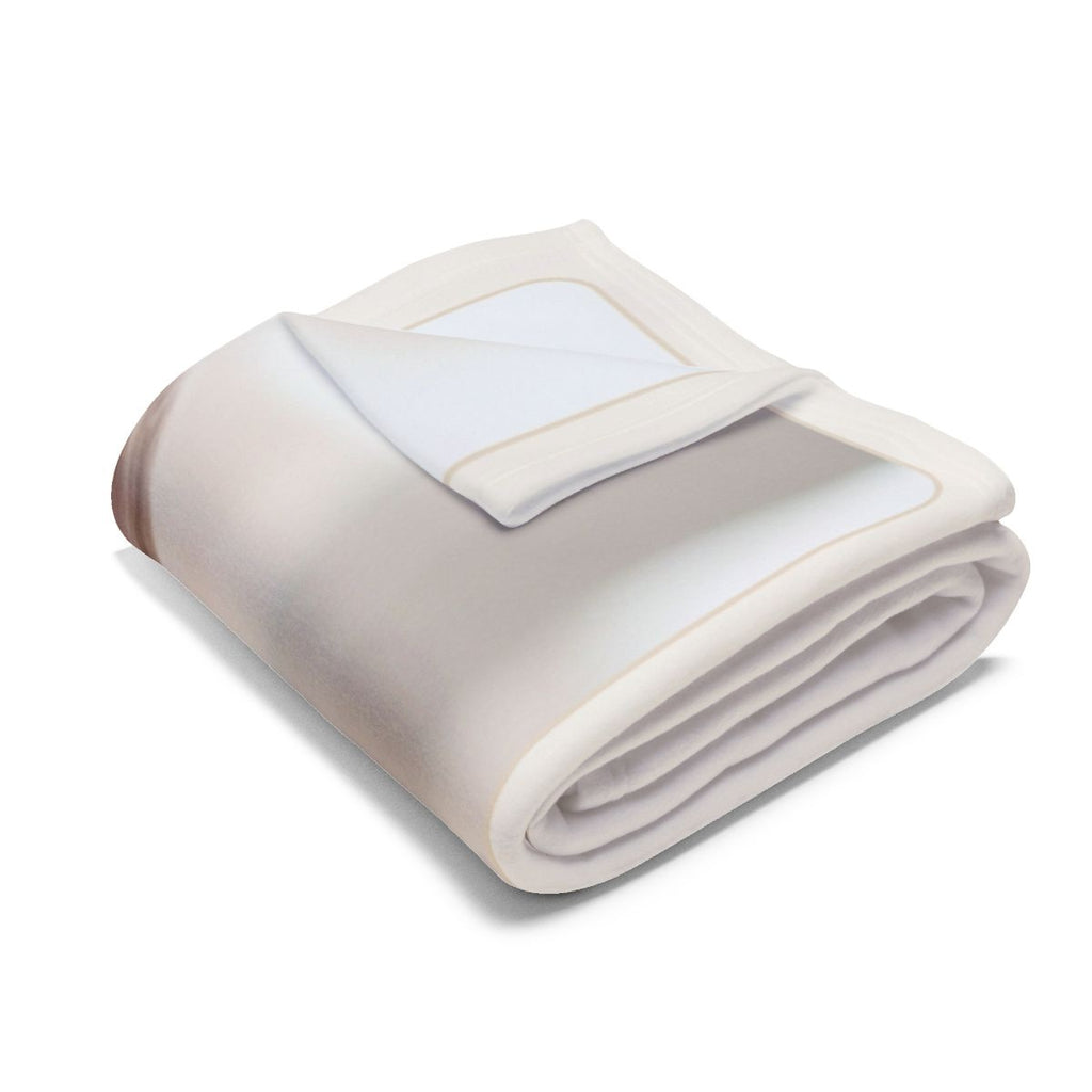 Baby photo fleece blanket folded into a bundle, showing the cream border and only a sliver of the print