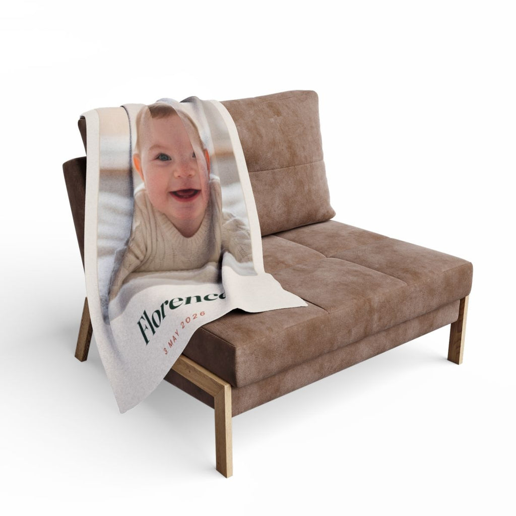 Baby photo fleece blanket mock-up draped over a brown armchair, the baby's photo and 'Florence' visible