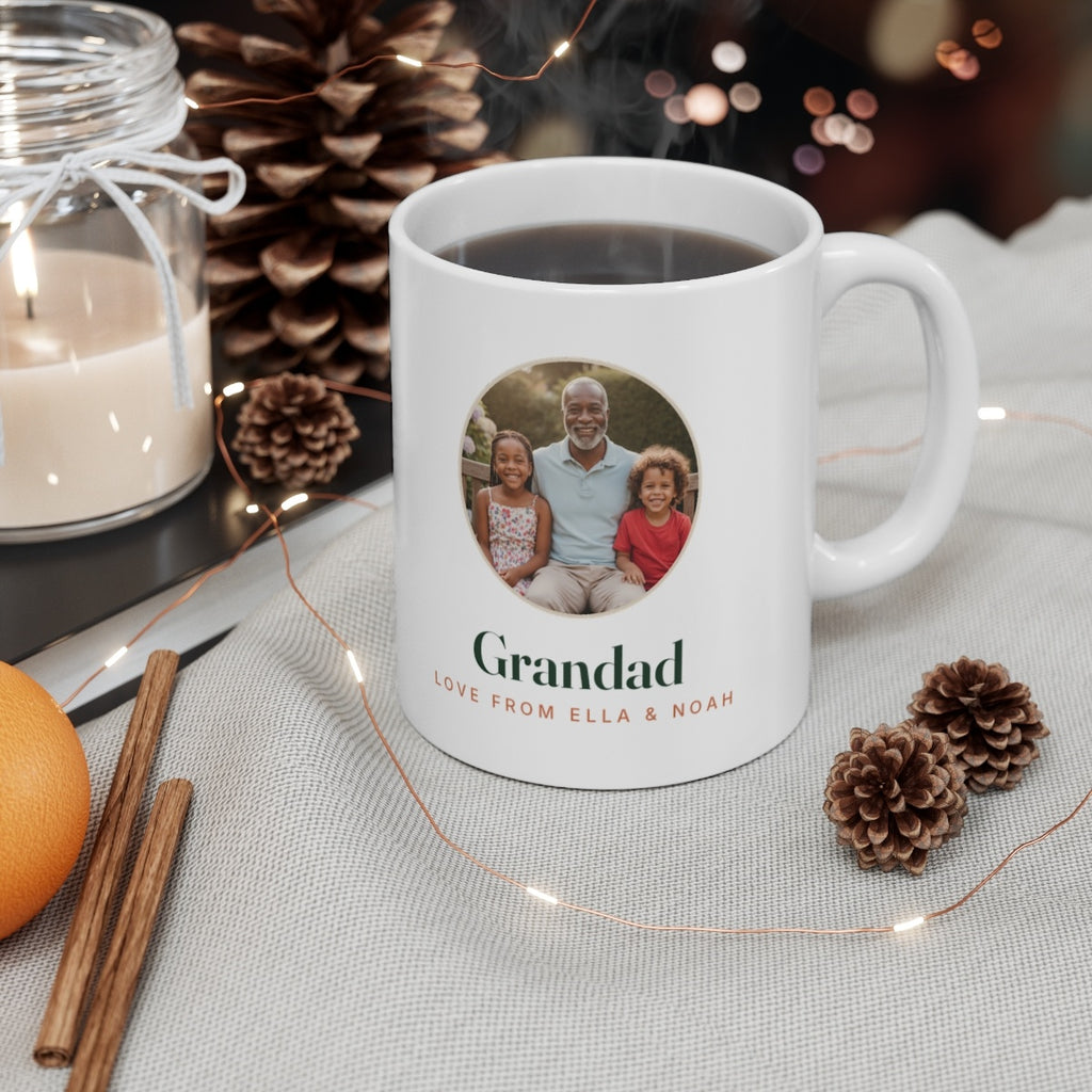 Grandparent photo mug mock-up filled with coffee on a table with a candle, pine cones, cinnamon sticks and fairy lights