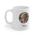 In Loving Memory photo mug mock-up, handle on the left, with an elderly woman's round photo, 'Nan' and '1941 to 2025'