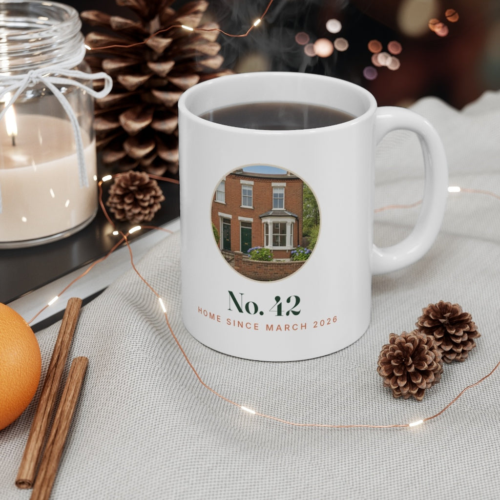 Personalised new home photo mug mock-up filled with coffee on a table among pine cones, a candle and fairy lights