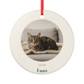 Personalised cat photo ceramic Christmas ornament mock-up on a red ribbon, with a tabby cat's photo, '2026' and 'Luna'