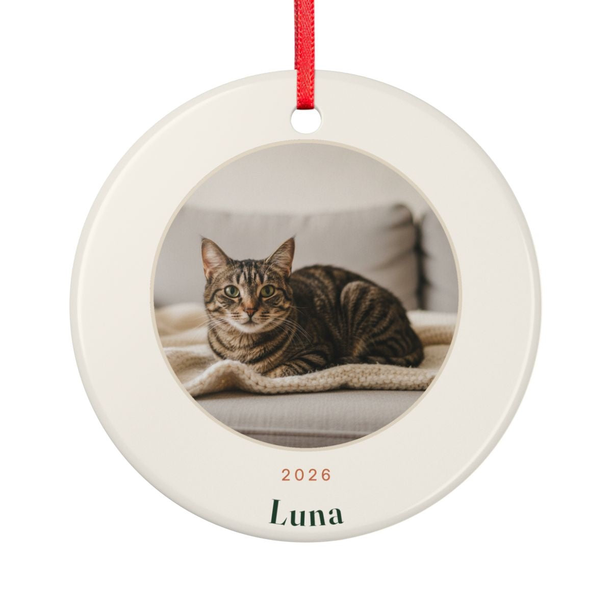 Cat photo ceramic Christmas ornament mock-up seen from the other side, with the same sample tabby cat photo, '2026' and 'Luna'