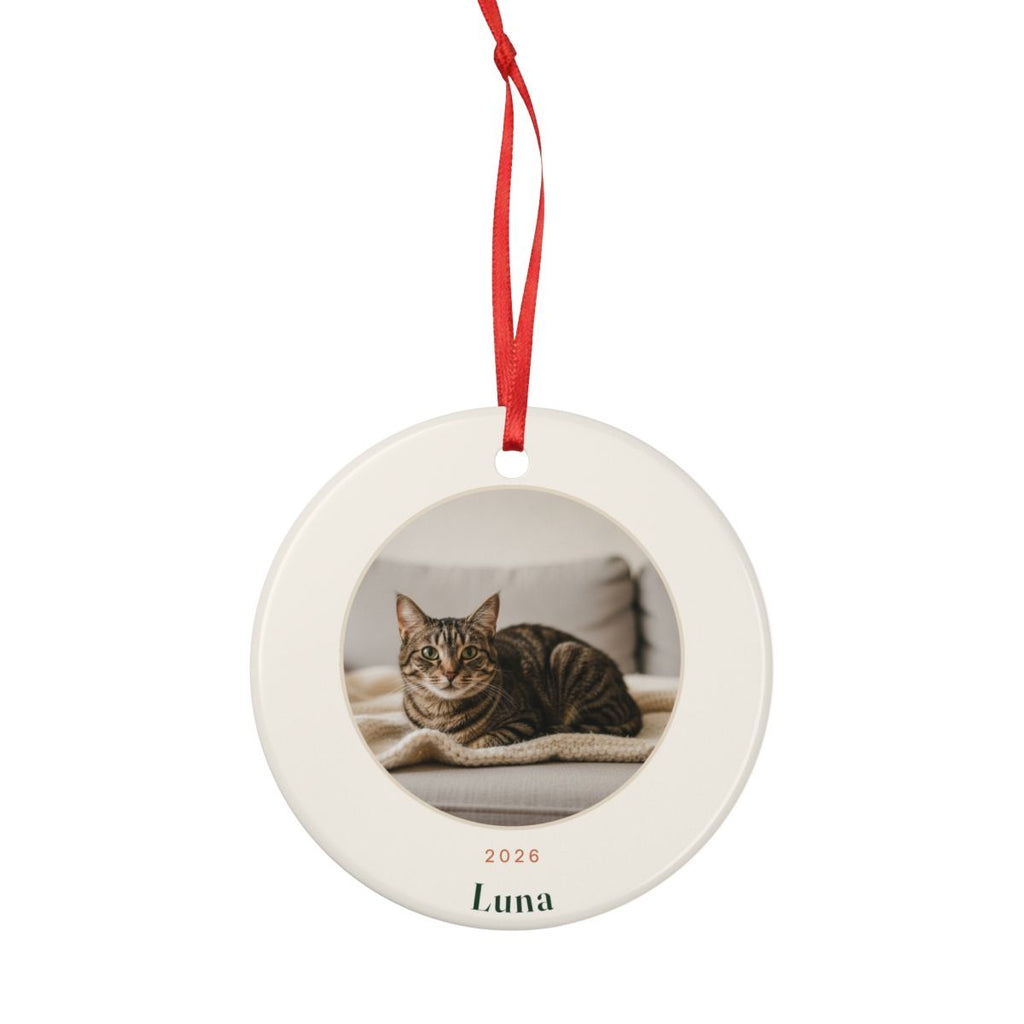 Cat photo Christmas ornament mock-up, round on a red ribbon, with a tabby cat photo, '2026' and 'Luna' printed below