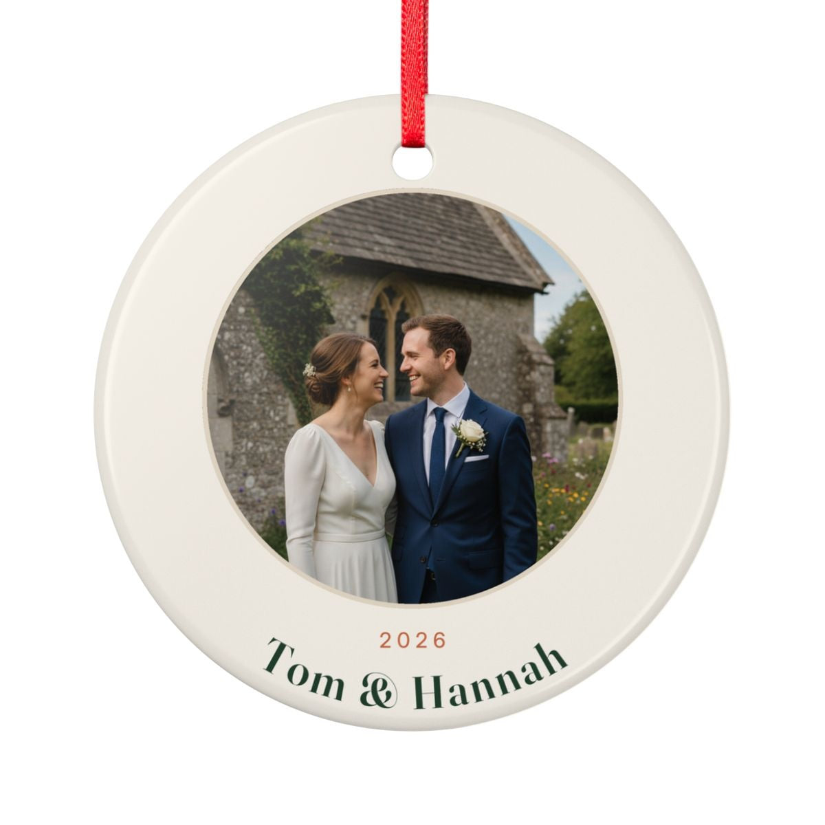 Personalised couple photo Christmas ornament mock-up, round ceramic ornament with a wedding photo, '2026' and 'Tom & Hannah'