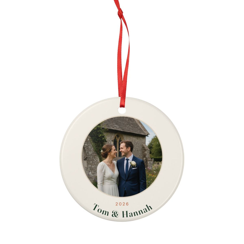 Personalised couple photo Christmas ornament mock-up hanging from a full-length red ribbon, showing the whole ornament