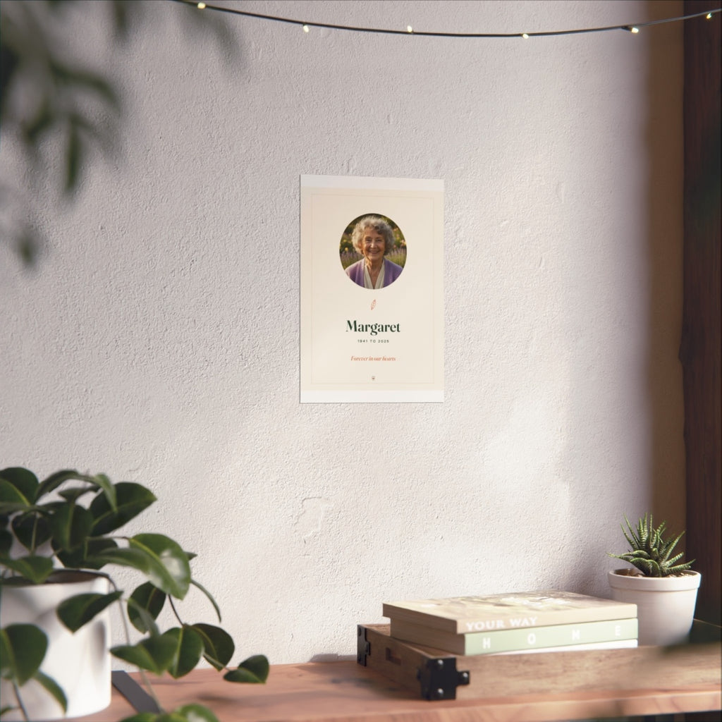 In Loving Memory photo print mock-up at the smaller size on a white wall above a desk with books and plants