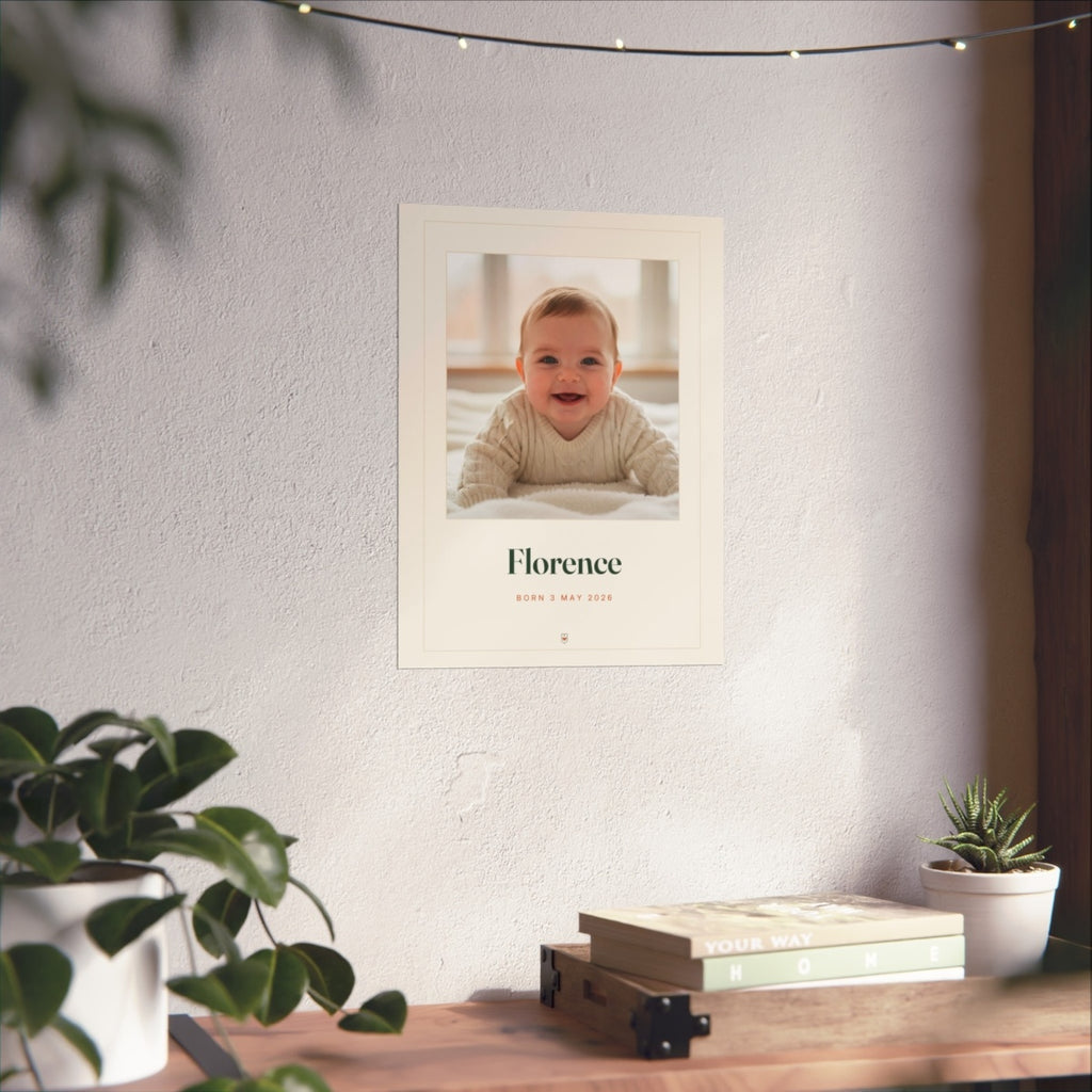 Baby photo print mock-up on a white wall above a desk with books, plants and fairy lights, larger size