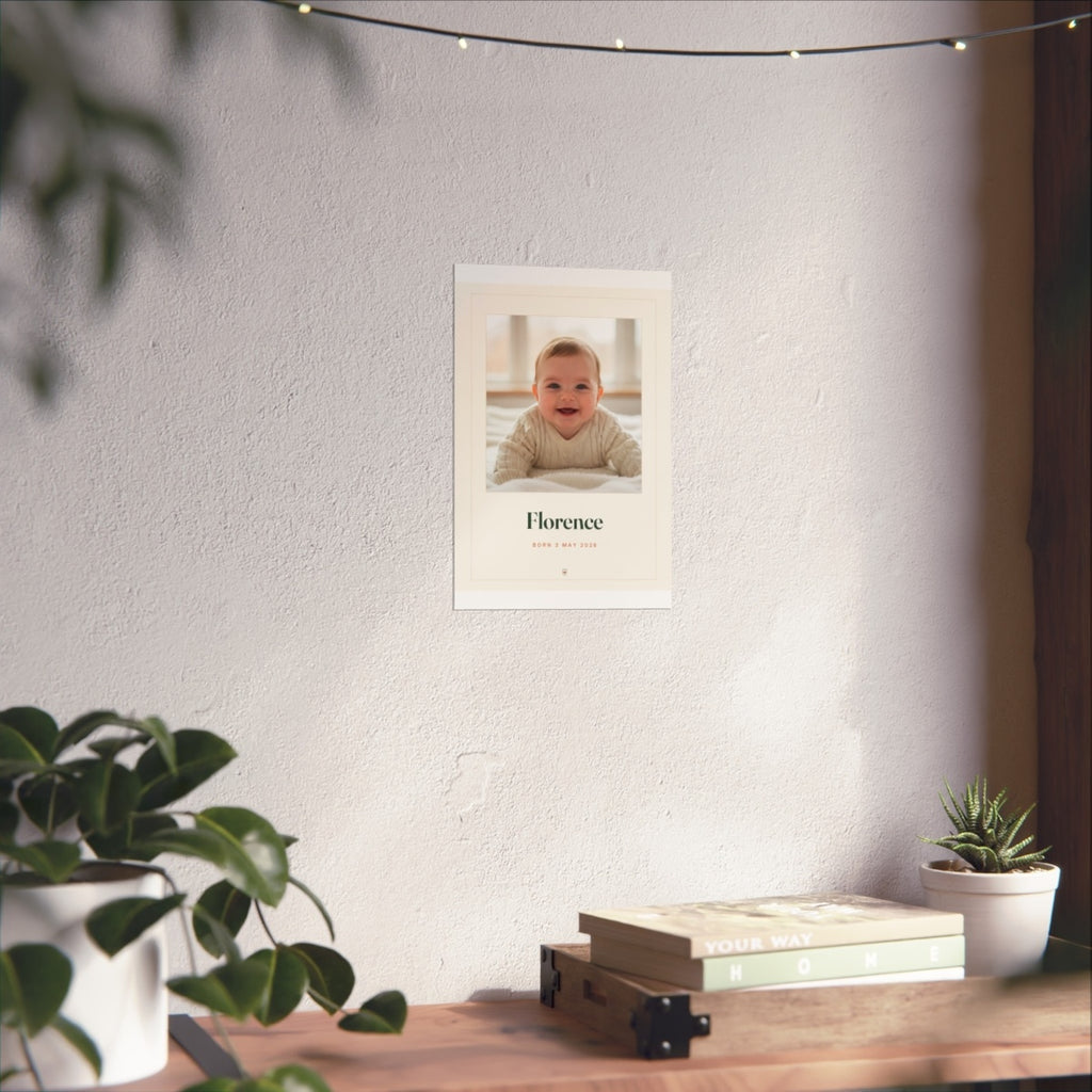Baby photo print mock-up at the smaller size on a white wall above a desk with books and plants
