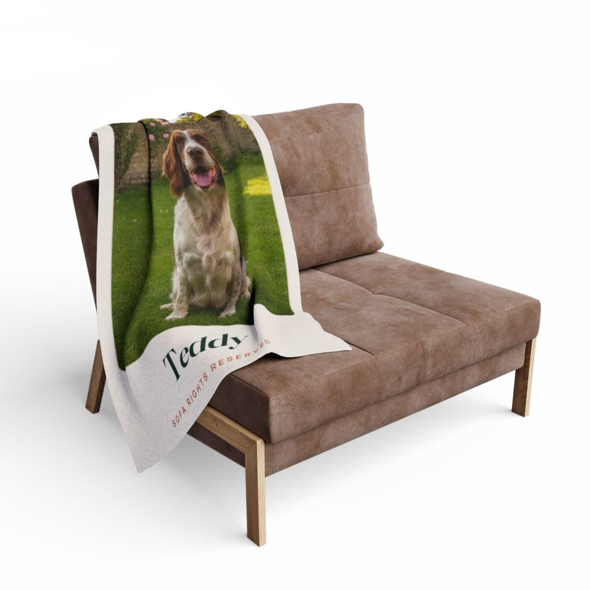 Dog photo fleece blanket mock-up draped over a brown armchair, the spaniel's photo and 'Teddy' visible