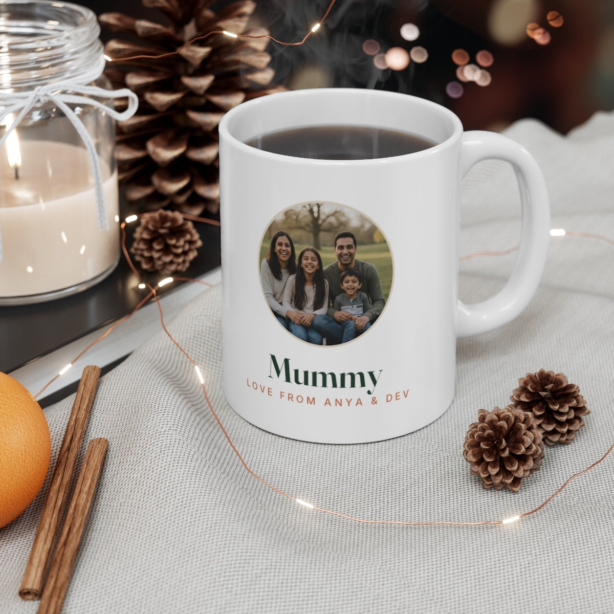 Personalised Mum photo mug mock-up filled with coffee on a table among pine cones, a candle and fairy lights