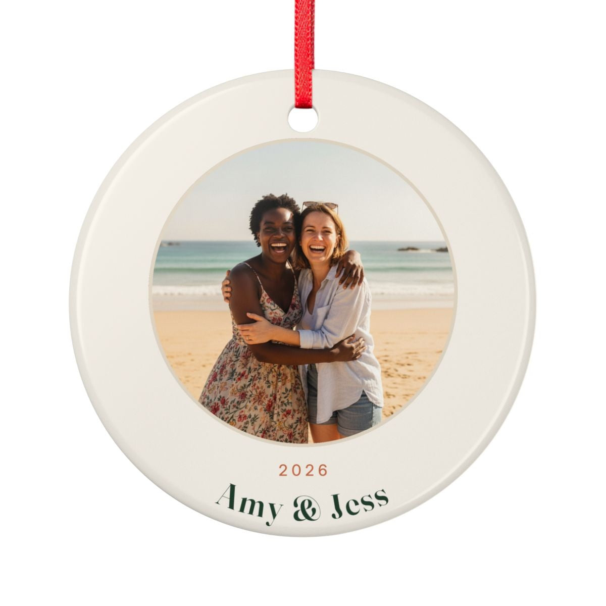 Personalised photo ornament for friends mock-up, round cream ceramic with a sample beach photo, '2026' and 'Amy & Jess'