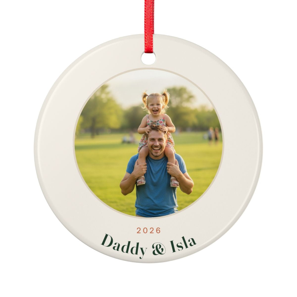 Personalised Dad photo Christmas ornament mock-up, round ceramic ornament with a child on her father's shoulders, '2026' and 'Daddy & Isla'