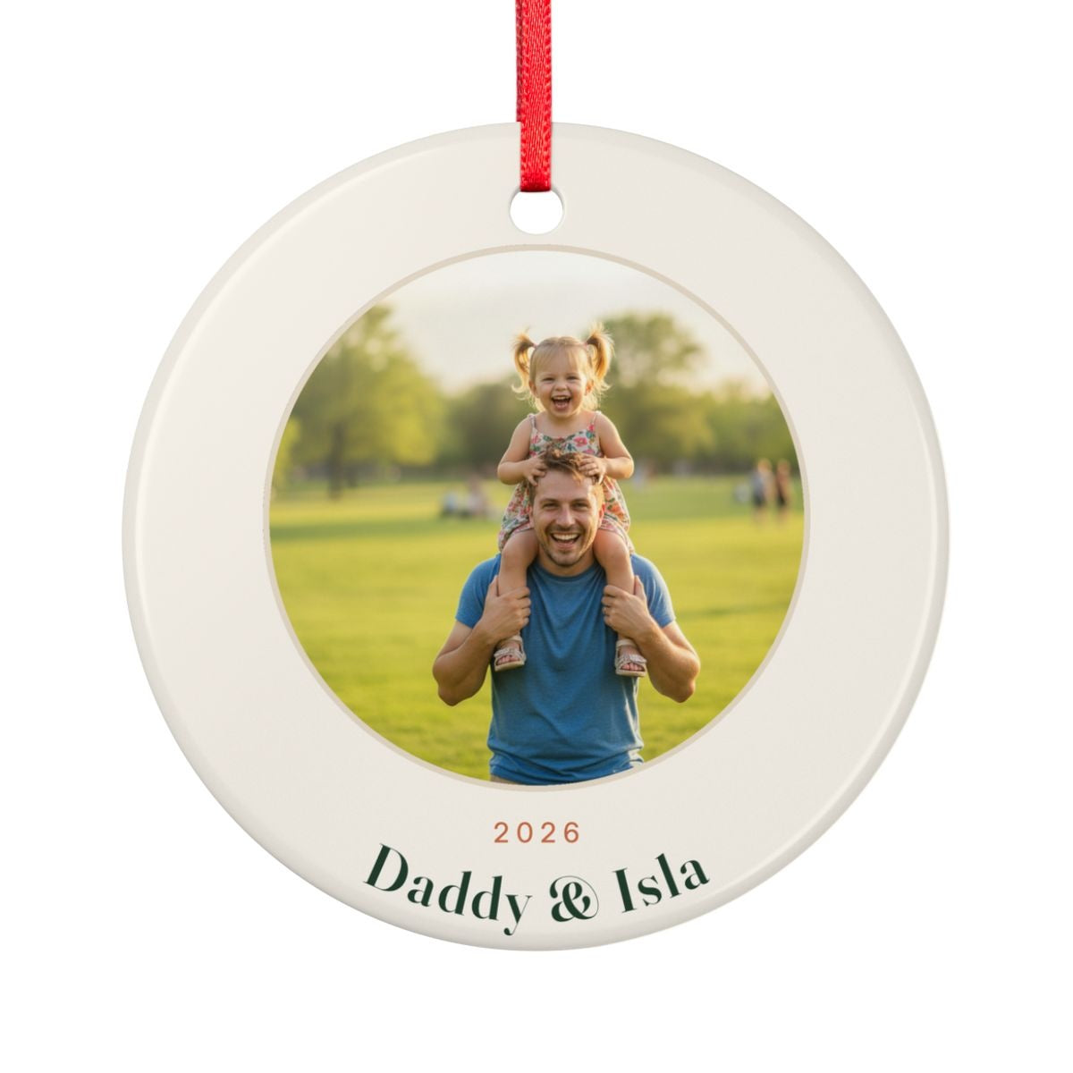 Dad photo Christmas ornament mock-up seen from the other side, with the same sample photo of a child on her father's shoulders, '2026' and 'Daddy & Isla'