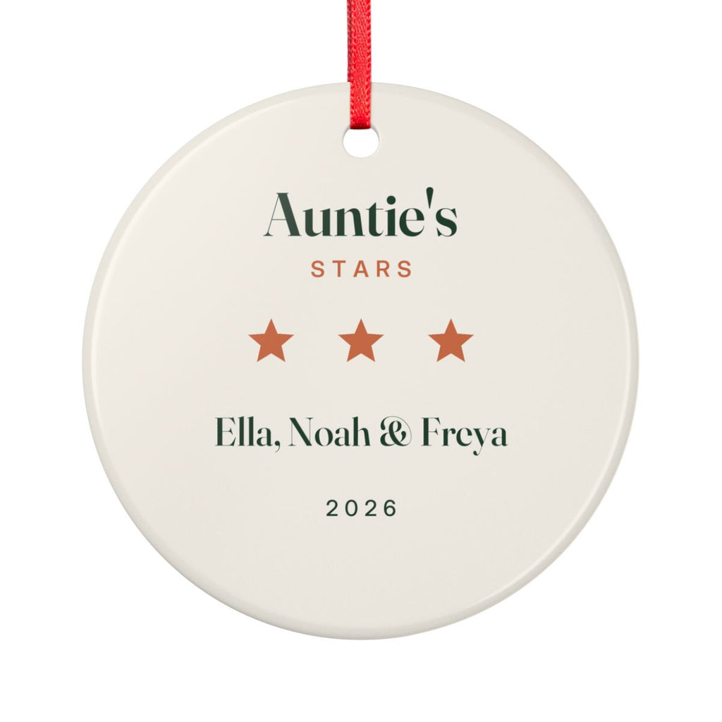 Auntie's Stars ceramic ornament mock-up seen from the other side, with the same three orange stars, 'Ella, Noah & Freya' and '2026'
