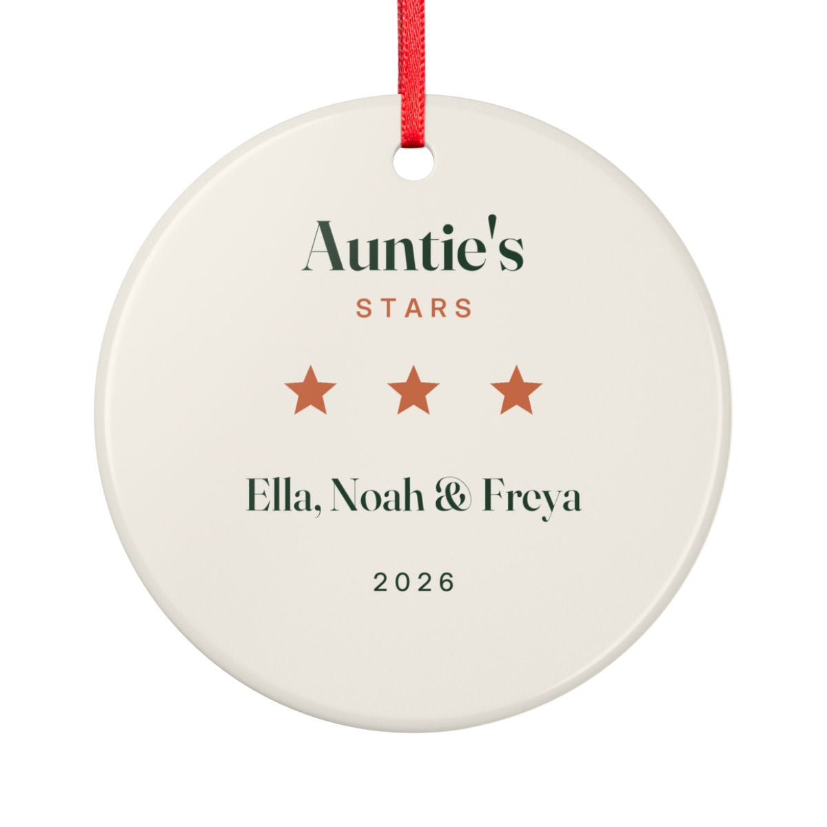 Auntie's Stars ceramic ornament mock-up seen from the other side, with the same three orange stars, 'Ella, Noah & Freya' and '2026'