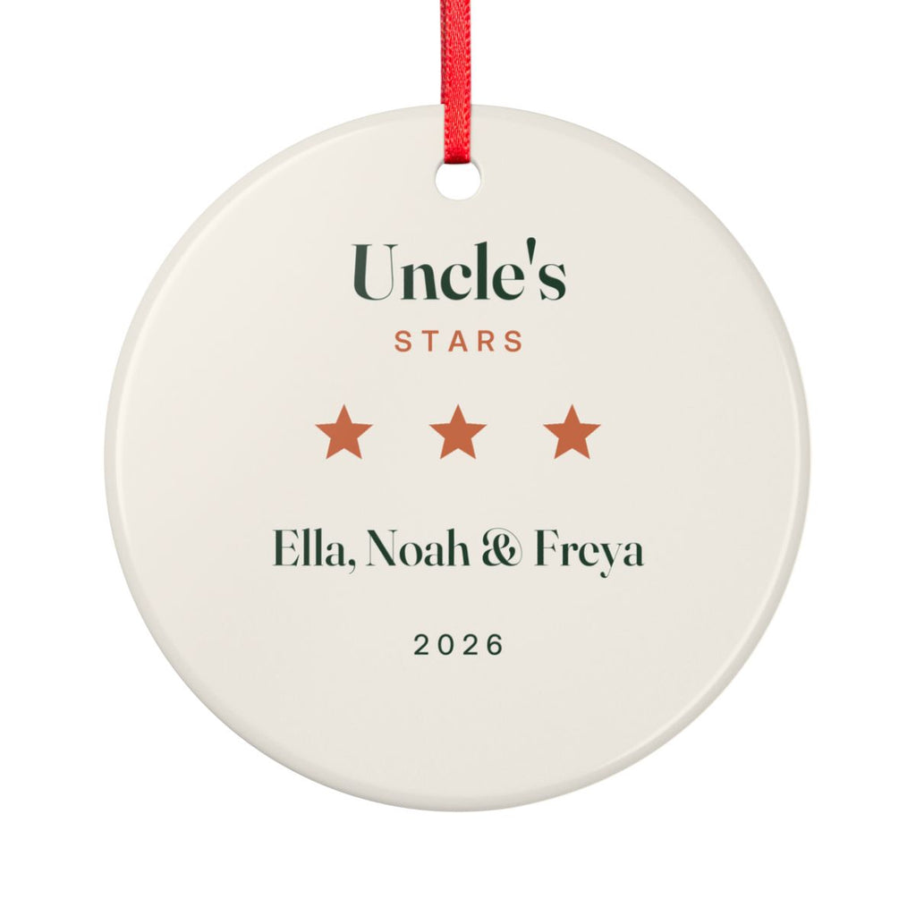 Uncle's Stars ceramic ornament mock-up seen from the other side, with the same three orange stars, 'Ella, Noah & Freya' and '2026'
