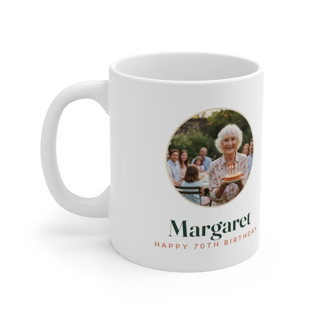 Personalised birthday photo mug mock-up, handle on the left, with a round sample photo, 'Margaret' and 'Happy 70th Birthday'