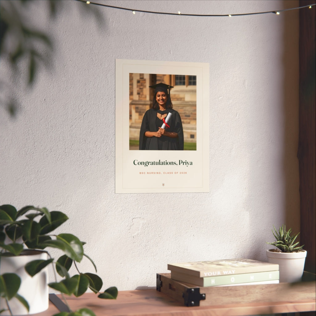 Personalised graduation photo print mock-up at the larger size on a white wall under string lights above a desk with books