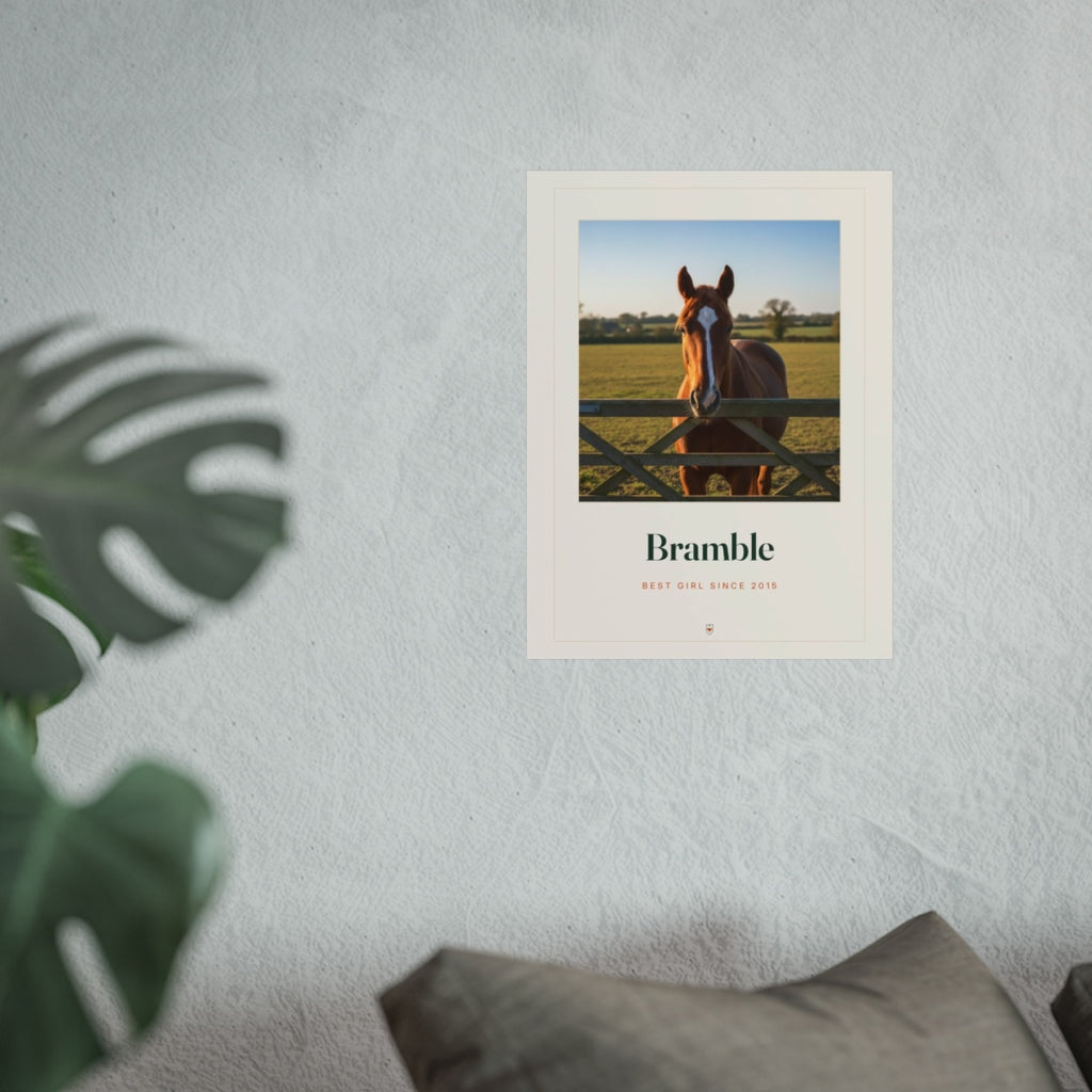 Personalised horse photo print mock-up hung on a grey wall above a sofa, with a monstera plant in the foreground