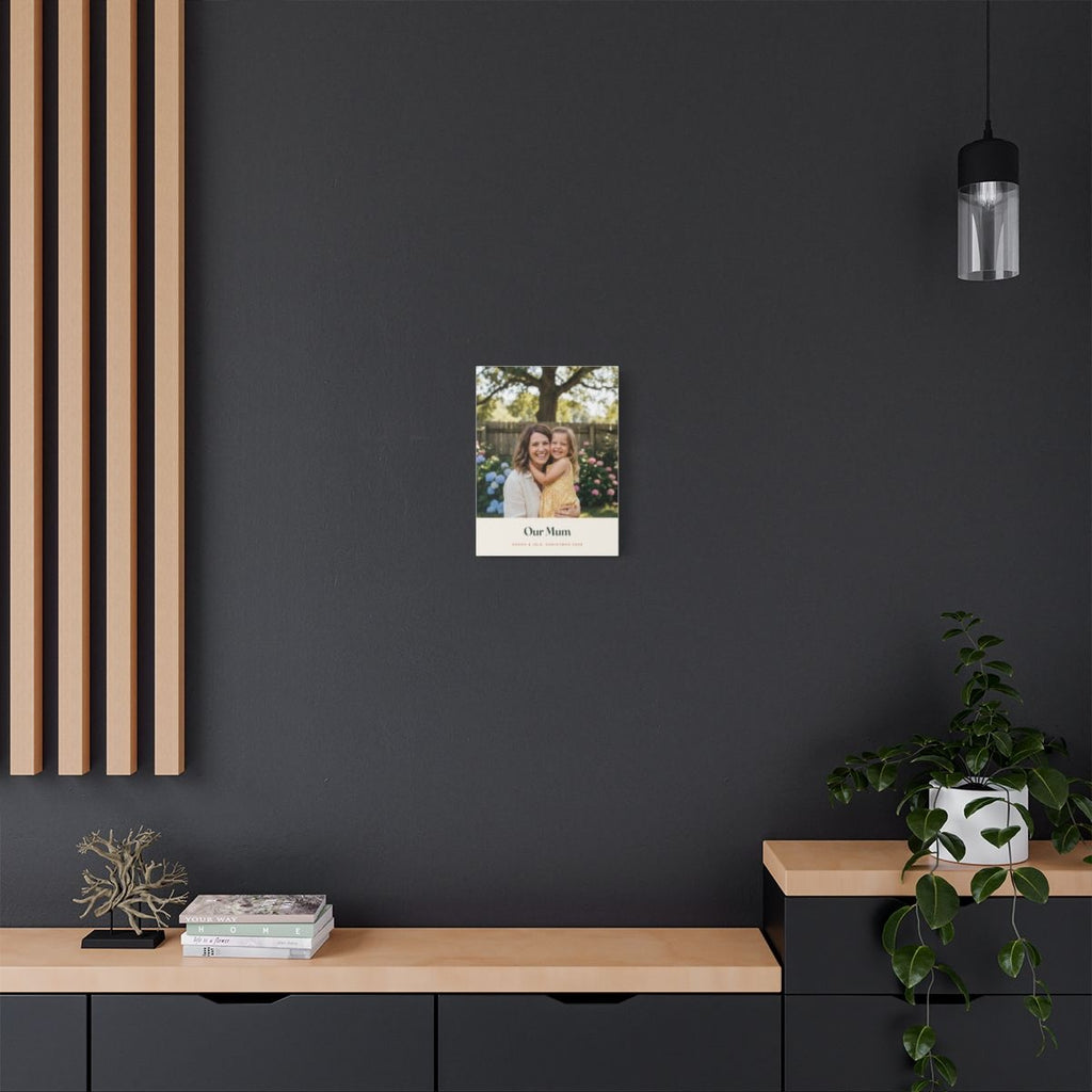 Personalised Mum photo canvas mock-up on a dark grey wall above a sideboard with a trailing plant and wooden slat panel