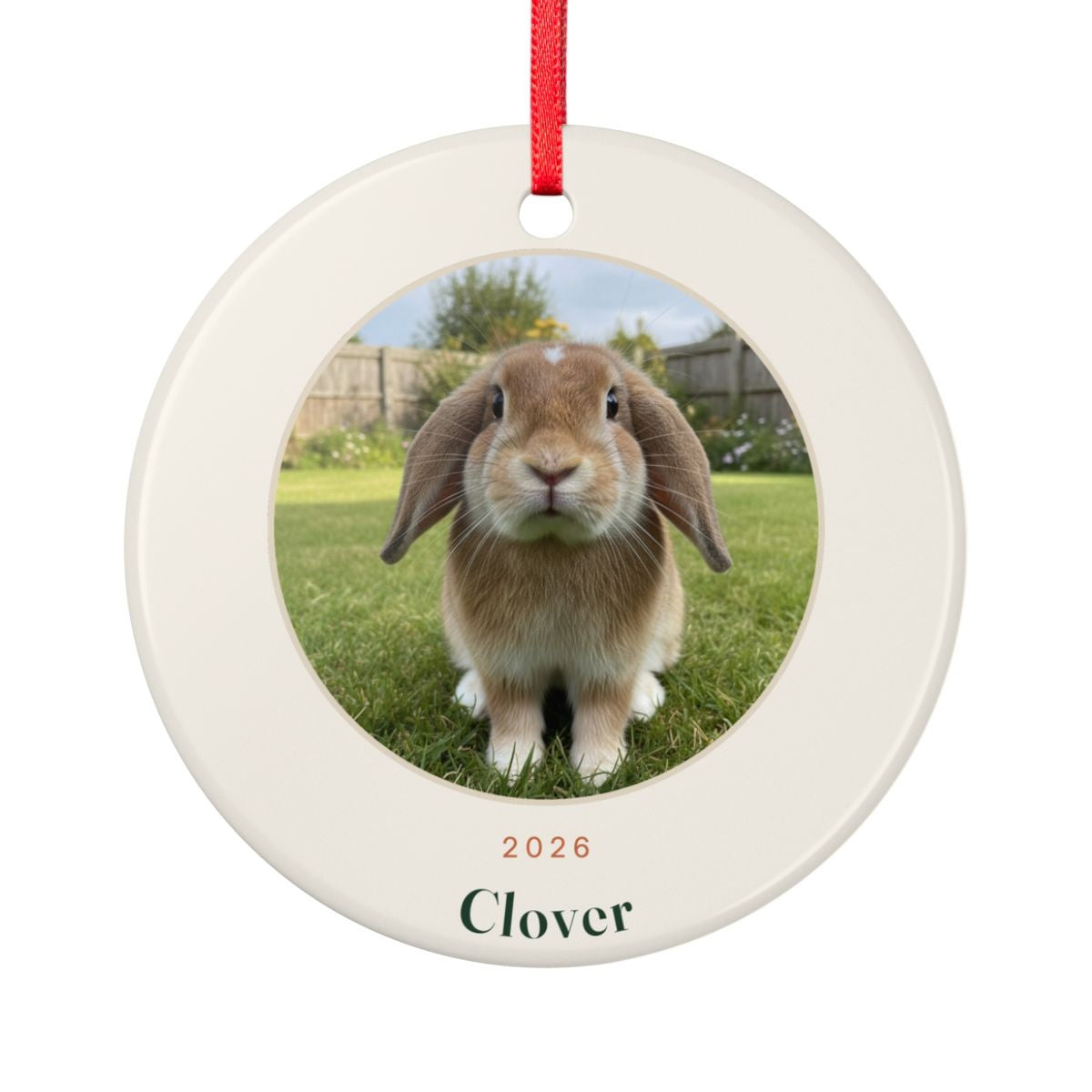 Personalised rabbit photo ceramic ornament mock-up with a sample lop-eared rabbit photo, 'Clover' and '2026', red ribbon