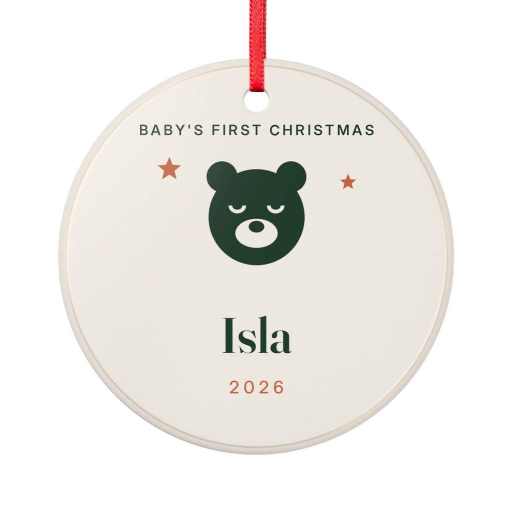 Baby's First Christmas ceramic ornament mock-up, round with a red ribbon, a green bear, two stars, 'Isla' and '2026'