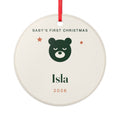 Baby's First Christmas ceramic ornament mock-up, round with a red ribbon, a green bear, two stars, 'Isla' and '2026'