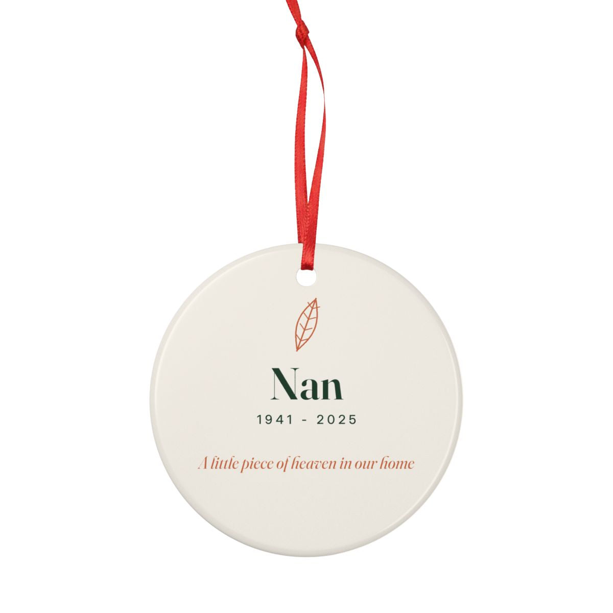 Personalised memorial ceramic ornament mock-up hanging from a long red ribbon, whole ornament shown smaller against white