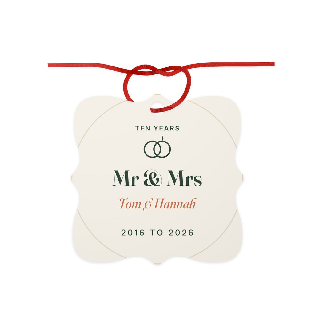 10th anniversary aluminium ornament mock-up with a red ribbon bow, 'Ten years', two rings, 'Mr & Mrs' and 'Tom & Hannah'