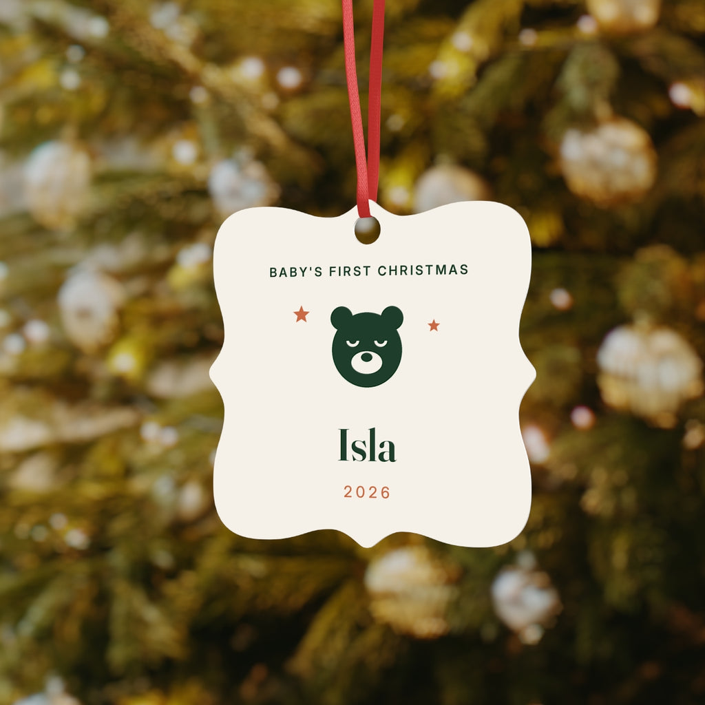 Baby's First Christmas aluminium ornament mock-up hanging on a Christmas tree, bear face and sample name 'Isla'