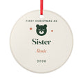 Personalised First Christmas as Sister ornament mock-up, round cream ceramic disc with a green bear, 'Sister', 'Rosie' and '2026'