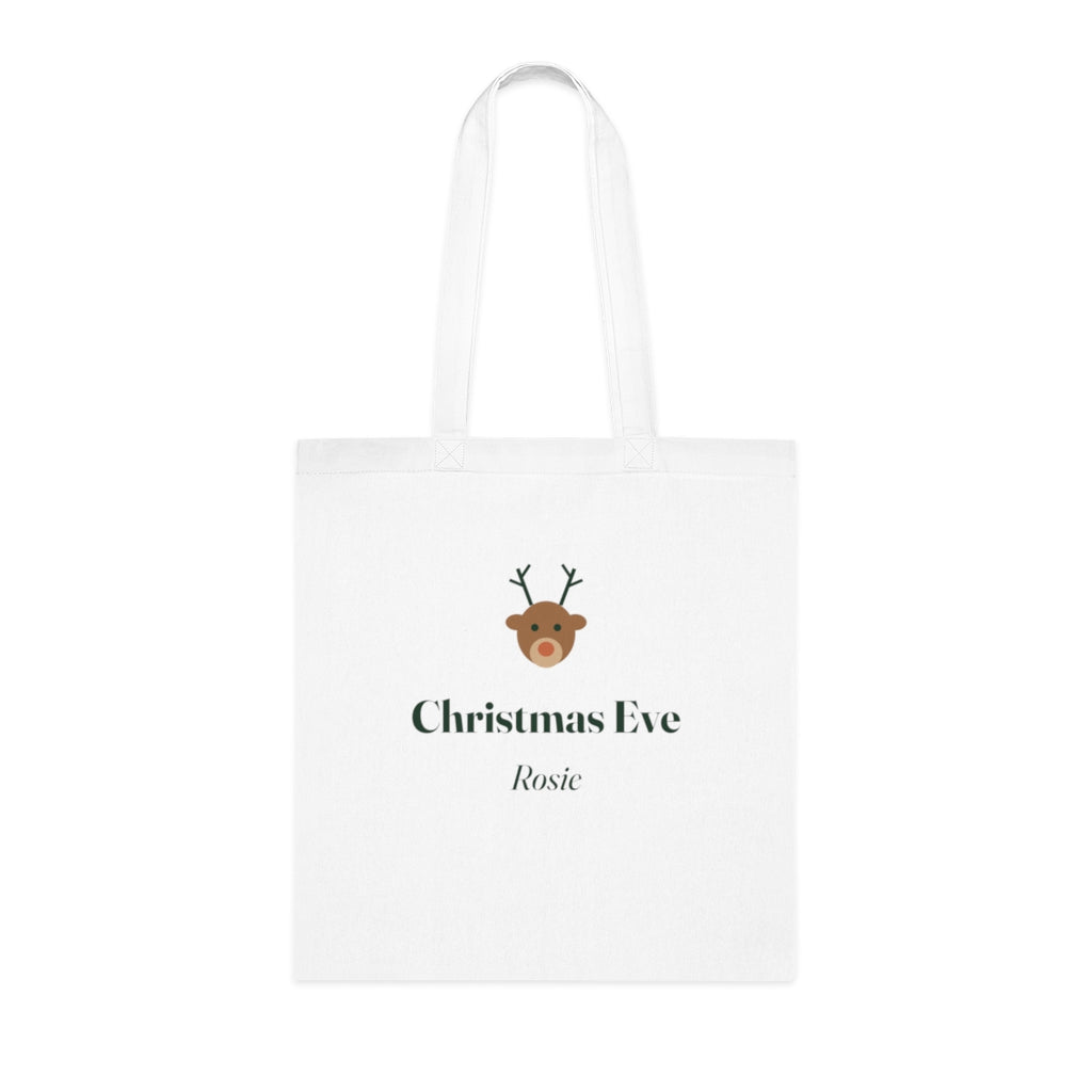 Personalised Christmas Eve white cotton tote bag mock-up laid flat, with a reindeer face, 'Christmas Eve' and 'Rosie'