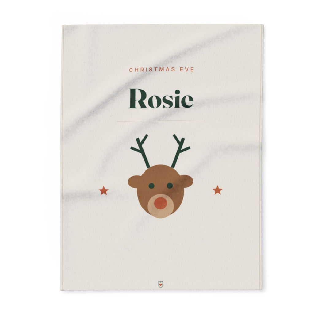 Personalised Christmas Eve fleece blanket mock-up laid flat, 'Rosie' in large letters and a reindeer face between two stars