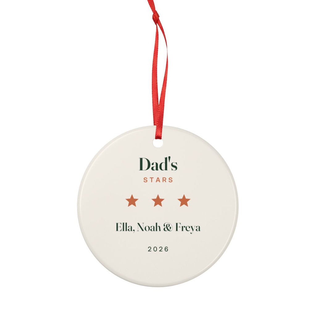 Personalised Dad's stars Christmas ornament mock-up hanging from a full-length red ribbon, showing the whole cream ornament
