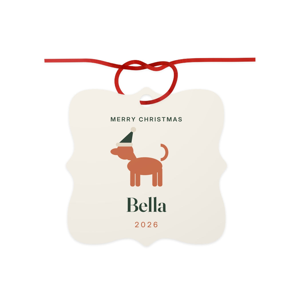 Dog aluminium Christmas ornament mock-up with a red ribbon bow, 'Merry Christmas', a dog in a Santa hat, 'Bella' and '2026'