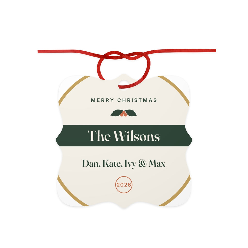 Family aluminium Christmas ornament mock-up with a red ribbon bow, holly, 'The Wilsons', 'Dan, Kate, Ivy & Max' and '2026'