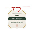 Family aluminium Christmas ornament mock-up with a red ribbon bow, holly, 'The Wilsons', 'Dan, Kate, Ivy & Max' and '2026'