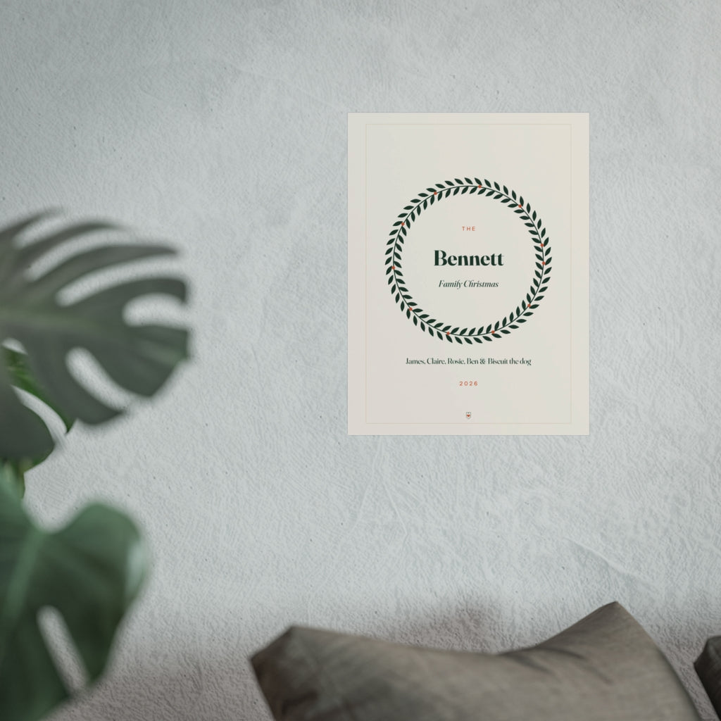 Personalised family Christmas print mock-up at the larger size on a pale wall above a sofa beside a monstera plant