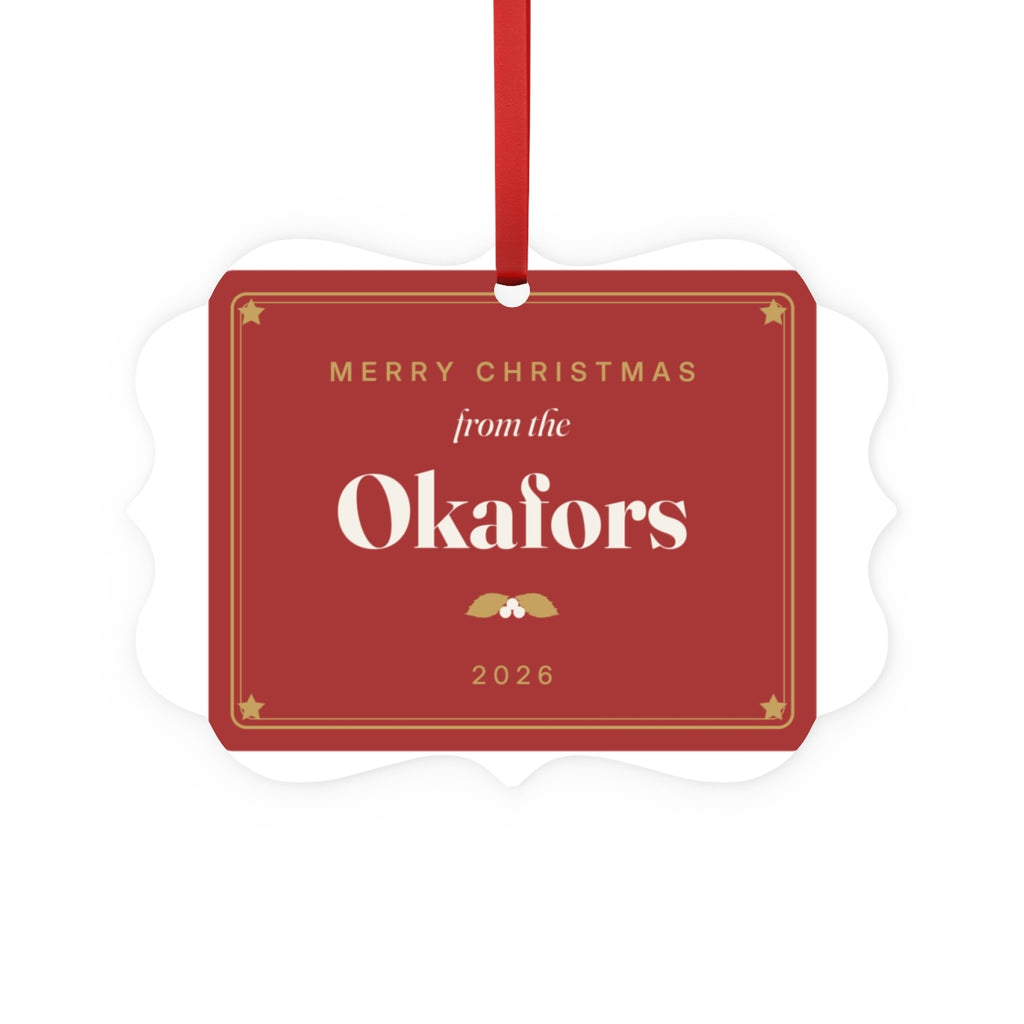 Family aluminium plaque ornament mock-up in red and gold with a ribbon, 'Merry Christmas from the Okafors' and '2026'