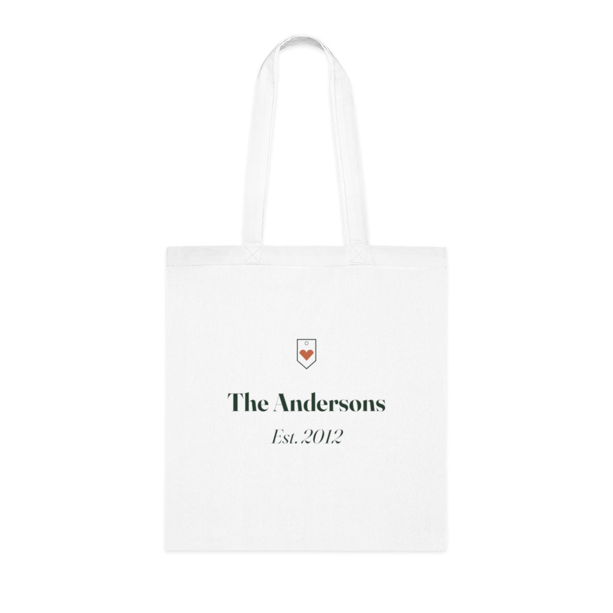 Personalised family name tote bag mock-up, white cotton with a small heart crest, 'The Andersons' and 'Est. 2012'