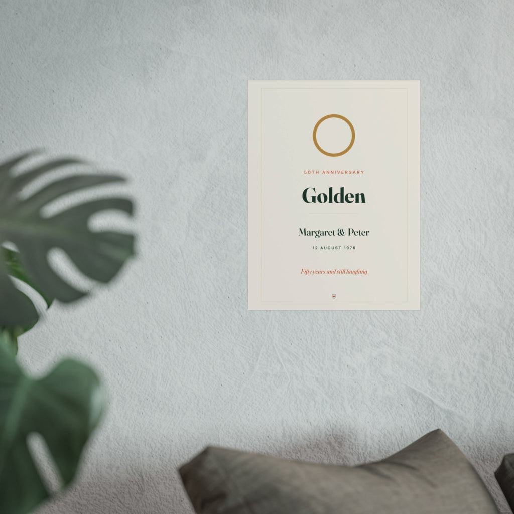 Personalised golden wedding anniversary print mock-up at the larger size on a pale wall above a sofa beside a monstera