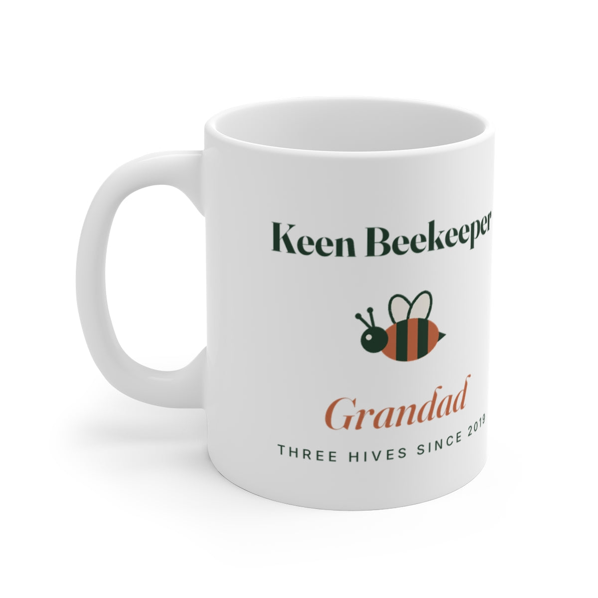 Personalised keen beekeeper mug mock-up, handle on the left, with a striped bee, 'Grandad' and 'Three hives since 2019'